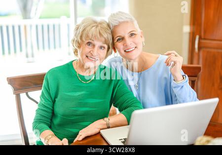 A daughter explaining some documentation to senior parent Stock Photo