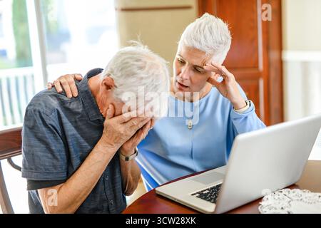 daughter explaining some documentation to senior parent Stock Photo