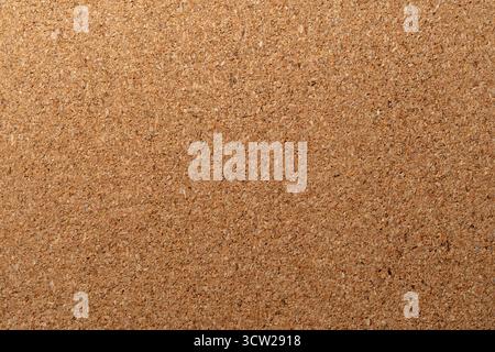 A natural, light brown corkboard or cork material. This textured background is ideal for presentations, concepts, bulletin boards. Stock Photo