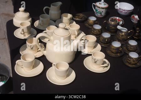 Tea service with tea pot cups and saucers at an outdoor market in Cambados Galicia Spain Stock Photo