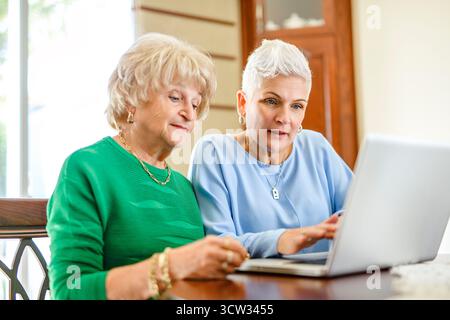 daughter explaining some documentation to senior parent Stock Photo