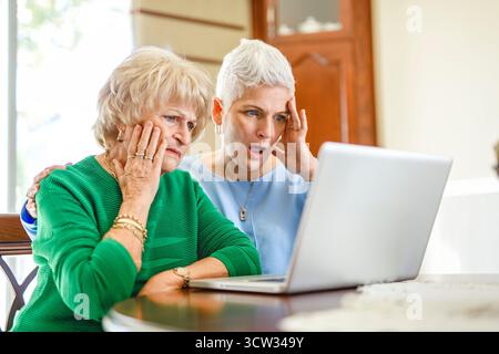 daughter explaining some documentation to senior parent Stock Photo