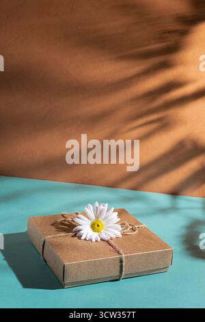 Craft gift box decorated with chamomile flower  Stock Photo