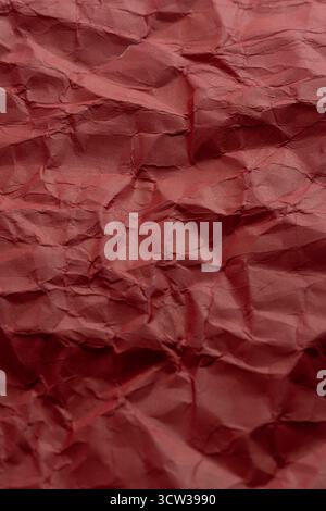 Crumpled red paper as background. Close up Stock Photo