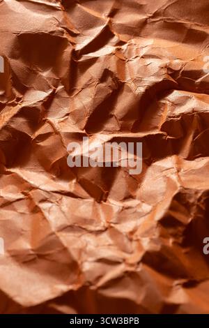 Crumpled orange paper as background. Close up image Stock Photo