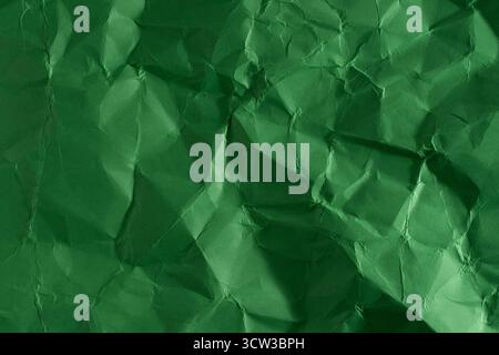 Green creased crumpled paper background grunge texture backdrop Stock Photo