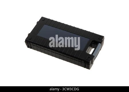 Black rugged power bank with a solar charging panel and a carry handle. Stock Photo
