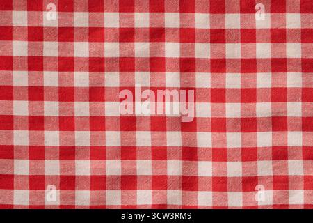 Red and white checkered fabric with classic gingham pattern commonly used in clothing, tablecloths and home decor. Stock Photo