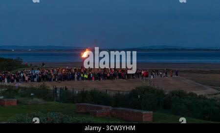 a large crowd gathers on the promenade at fairhaven lake to celebrate lighting the beacon to celebrate the 80th anniversary of VE day Stock Photo