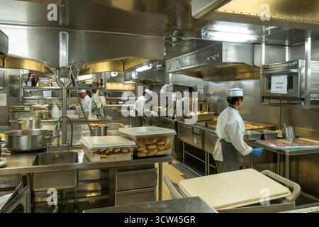 Atlantic Ocean - Oct 1, 2025 A busy professional kitchen with multiple chefs working among stainless steel equipment, commercial appliances, and a var Stock Photo