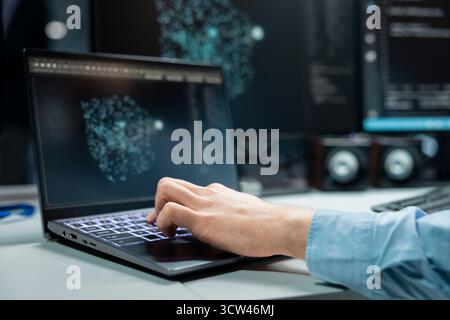Close up of programmer typing on laptop keyboard, optimizing performance with AI assistant analysis. Data center IT expert using notebook to speed up tasks by following LLM chatbot suggestions Stock Photo