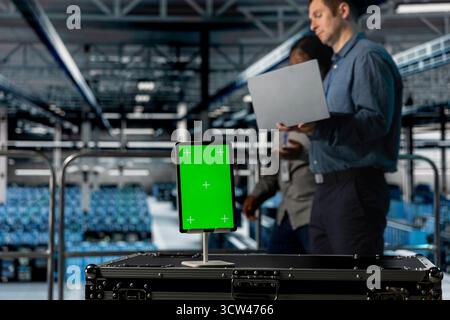 Close up of isolated screen tablet used by teamworking data center admins to reduce downtime. Server hub coworkers monitoring equipment performance using software on mockup device Stock Photo