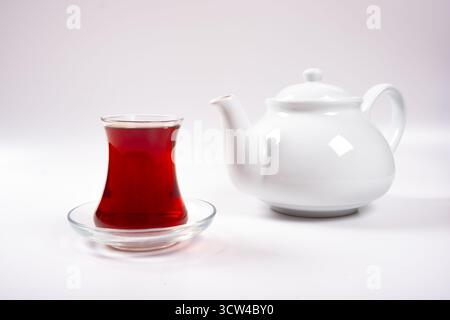 Cup of tea and teapot, a cup of tea and porcelain teapot isolated on a white background Stock Photo