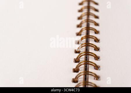 Blank spiral bound notebook. Close-up of blank paper notebook in a binder with metal ring binding, macro Stock Photo