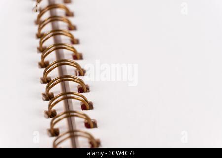 Blank spiral bound notebook. Close-up of blank paper notebook in a binder with metal ring binding, macro Stock Photo