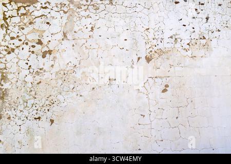 Cracked weathered outdoor whitewashed plaster wall - texture and background Stock Photo