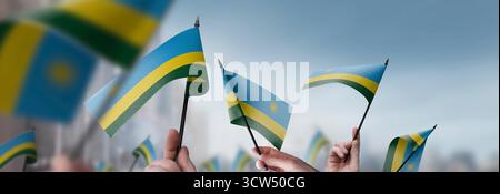 Rwanda flag in hand. Patriotic background. National flag of Rwanda ...