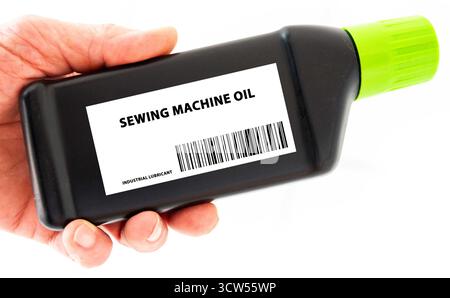 Sewing Machine Oil Low-viscosity oil used in sewing machines to reduce friction and prevent wear on moving parts. Stock Photo