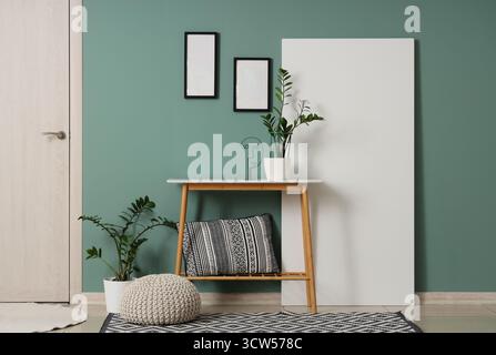 Bench, pouf, folding screen and houseplants in interior of modern hall Stock Photo