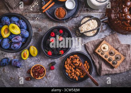Freshly picked berries and plums with healthy baking ingredients Stock Photo