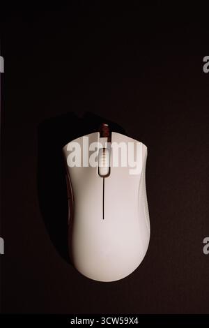 White wired gaming mouse on dark background top view Stock Photo