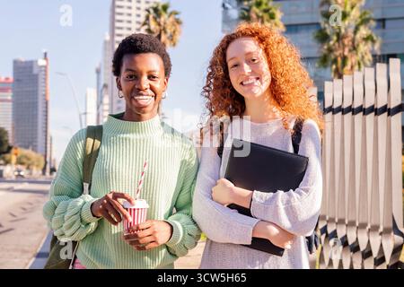 two young students smiling happy looking at camera Stock Photo