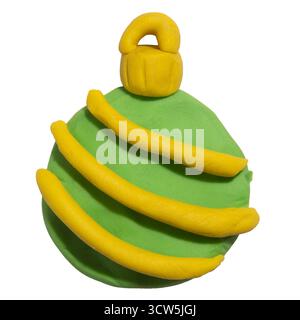 A Christmas bauble sculpted from children’s play clay, featuring the colors of green and yellow isolated on white background with clipping path Stock Photo