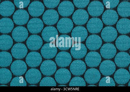 Fabric swatch color sample material pattern blue circles on black cloth. Stock Photo