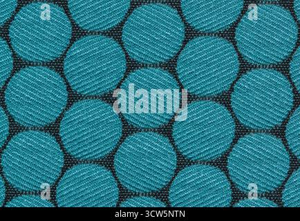 Fabric swatch color sample material pattern blue circles on black cloth. Stock Photo