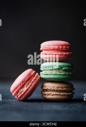 Close up of assorted macaron cookies on black background. Stock Photo