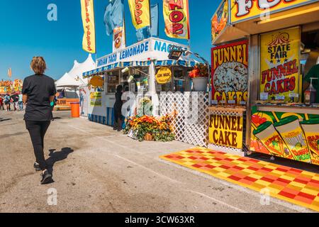 People walking along Fair ordering Food Stock Photo