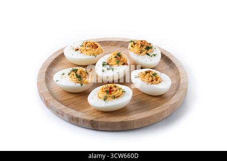 Homemade hard Boiled Deviled Eggs garnished with herbs isolated on white background. Stock Photo