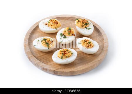 Homemade hard Boiled Deviled Eggs garnished with herbs isolated on white background. Stock Photo