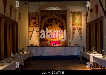 Interior view of medieval banquet hall with tables and tapestries in Dover Castle. Stock Photo
