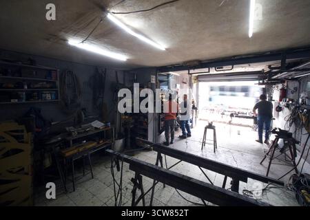 Metal workshop interior with tools, machinery and workers in Mexico Stock Photo