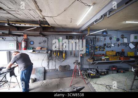Metal workshop interior with tools, machinery and workers in Mexico Stock Photo