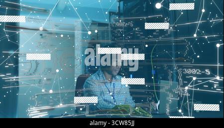 Connecting ethernet cables tech wearing checkered shirt monitoring network on laptop in server room. Technology, cybersecurity, data, network, infrast Stock Photo
