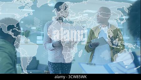 Collaborating four colleagues exchanging documents on tablet in modern office, with map overlay. Professional, teamwork, innovation, digital, workspac Stock Photo