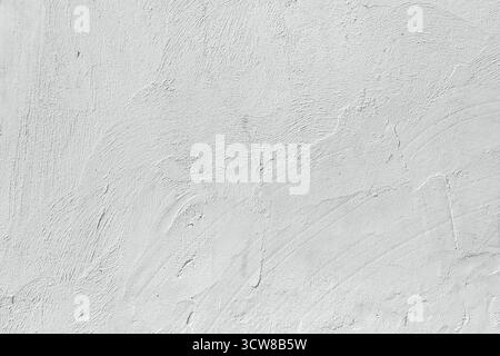 The background of a white plastered wall with fine grains and uneven surfaces. Visual tactile effect. Stock Photo