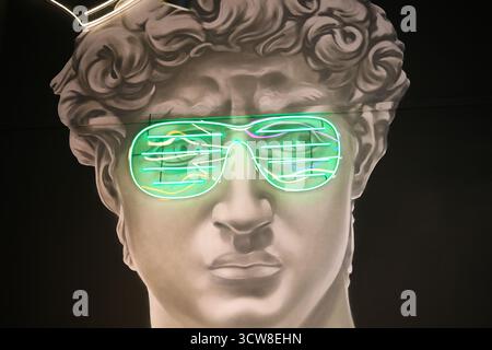 Plaster sculpture with modern neon glasses Stock Photo