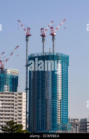 Urban development showing a new high-rise building being built in a modern city Stock Photo