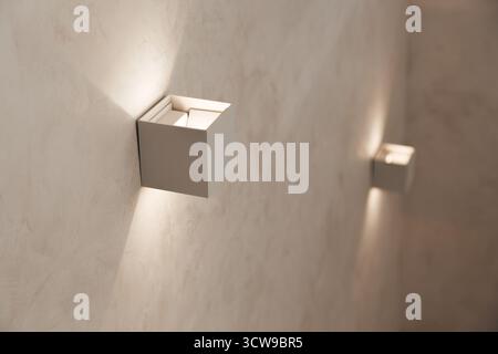 Small wall lamps on the staircase in a private house Stock Photo