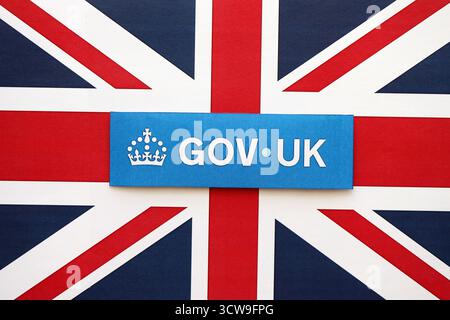 KYIV, UKRAINE - SEPTEMBER 17, 2025 Government GOV UK logotype sticker lies on UK flag close up Stock Photo