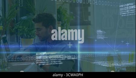 Coding male software developer wearing casual shirt focusing on laptop in office space, with plants Stock Photo