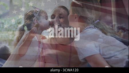 Mother and daughters sharing moment on living room sofa, with cookie, tiaras and flag overlay Stock Photo