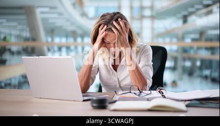 Frustrated Accountant Woman Working At Computer Desk Stock Photo