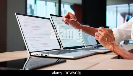 Developer Office: Coding And Developing Software On Computer Screens Stock Photo