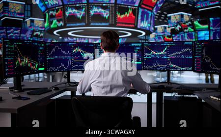 Senior Trader Analyzing Market Data On Computer At Stock Exchange. Stock Photo