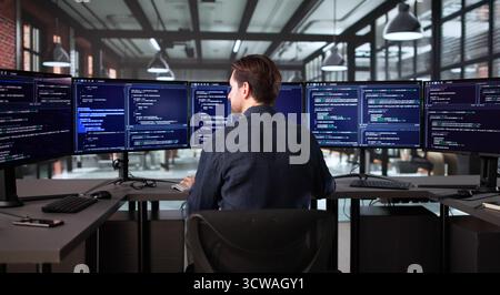 Senior Programmer Developing Cyber Security App On Office Computer Screen Stock Photo