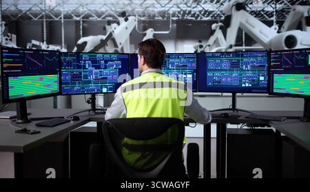 Senior Manufacturing Engineer Uses SCADA System To Monitor Vehicle Production. Stock Photo
